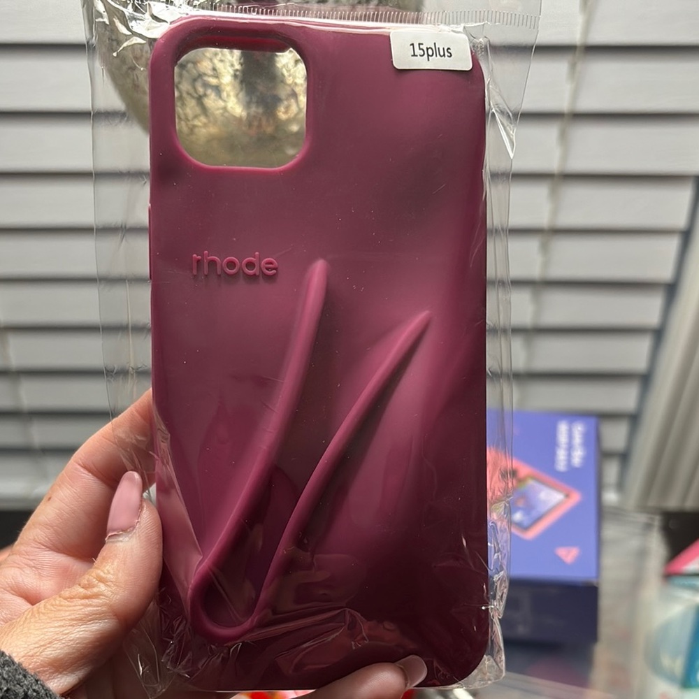 RHODE Maroon Phone Case for 15 Plus with matching lip gloss.